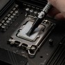 Kryonaut thermal paste being spread across a processor with the spatula attached to the syringe