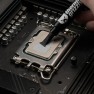 Kryonaut thermal paste being spread across a processor with the spatula attached to the syringe