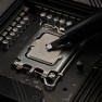 A dab of Kryonaut thermal paste placed on a processor with the spatula attached to the syringe