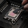 Kryonaut Extreme thermal paste being spread across a processor with a spatula