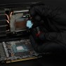 Putty Advance being scooped from the jar with a spatula, over an opened graphics card