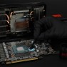 Putty Advance being applied to a graphics card with a spatula, gloves on