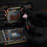 Putty Basic being scooped from the jar with a spatula, over an opened graphics card